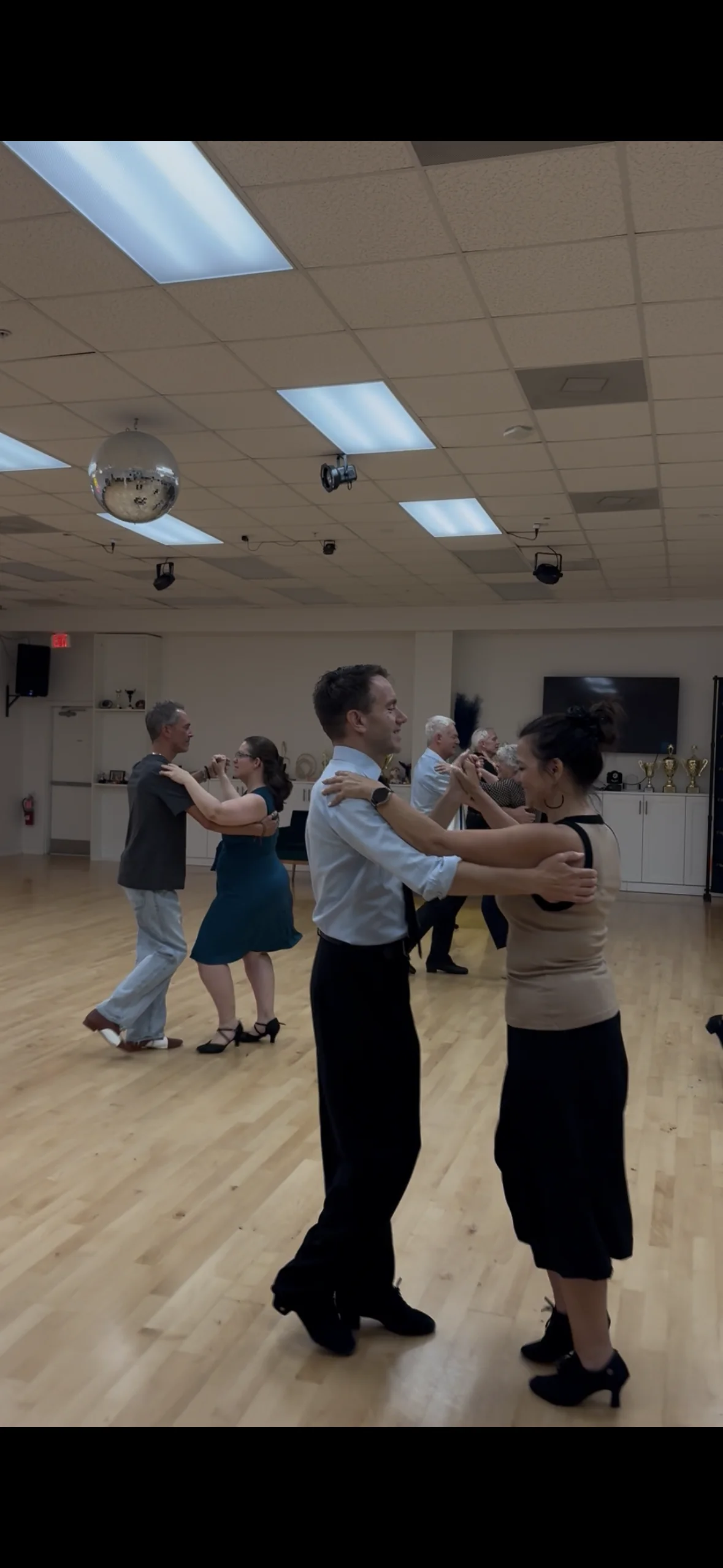 Couples dancing together in a partner class on the studio floor at S-Style Dance Team